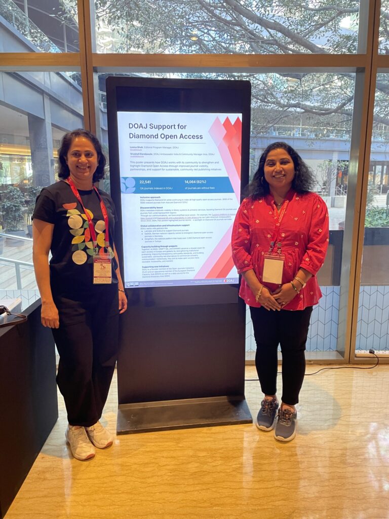 Leena Shah and Vrushali Dandawate standing next to their digital poster at the 3rd Global Summit Diamond Open Access 2026
